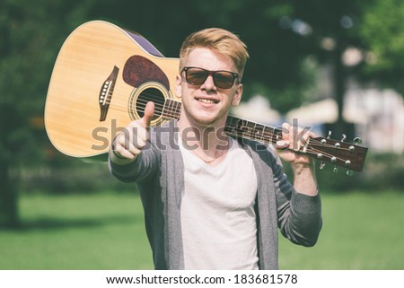 Young Russian Man Holding Guitar