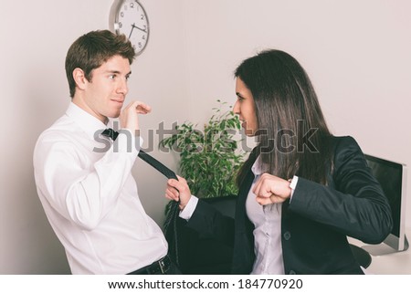 Bully Businesswoman Holding Colleague\'s Necktie
