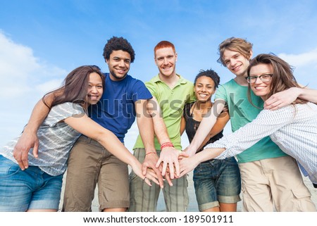 Multiracial Group of Friends with Hands on Stack