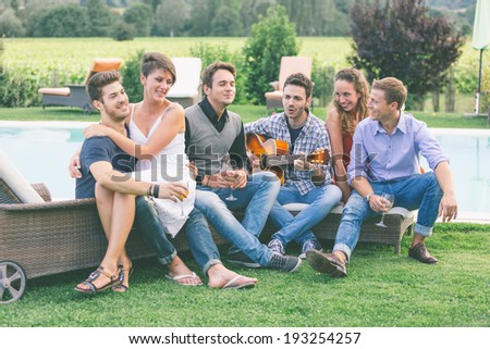 Group of Friend Singing Together next to Swimming Pool