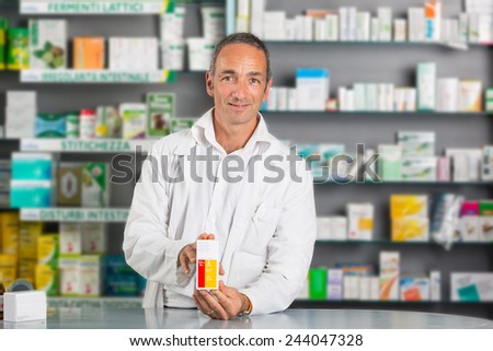Handsome Pharmacist at Work in a Drugstore