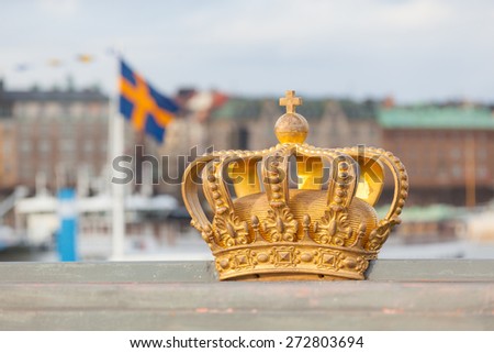 Golden crown with swedish flag on background in Stockholm.