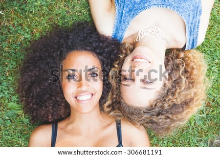 Similar – Image, Stock Photo Happy multiracial women lying together on grass