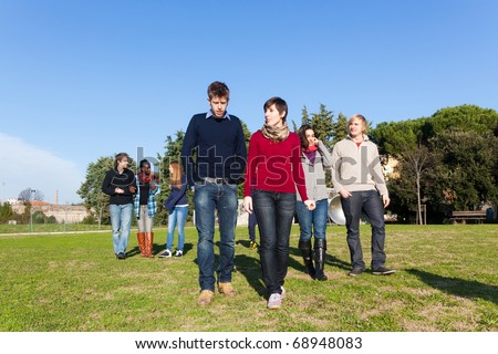 College Students Walking and Talking at Park