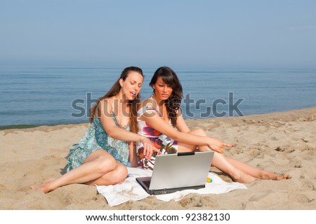 Two Women with Computer at Seaside