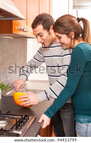 Wife and Husband Cooking Together in the Kitchen