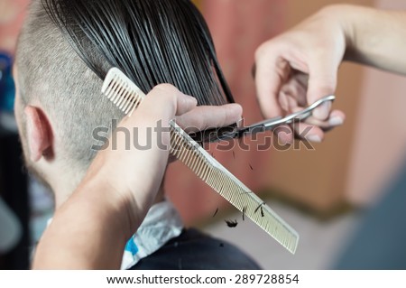 Men\'s hairstyling and haircutting in a barber shop or hair salon.