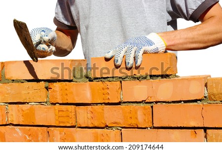 bricklayer laying bricks to make a wall