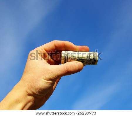 Money in hand on sky