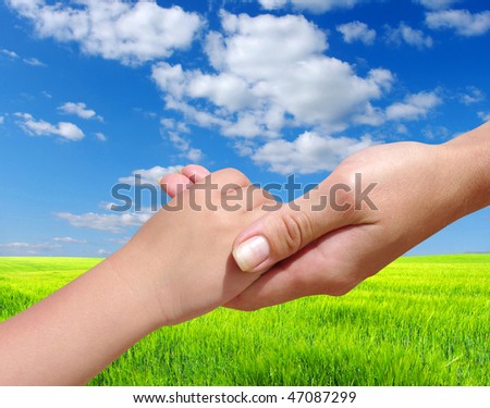 Child  holds the hand of the mother