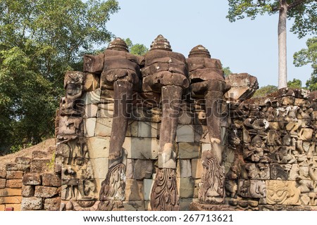 Ancient ruins at Wat Ta Prohm. near the archaeological site of Angkor Wat Siem Reap Cambodia. Three elephants carved out of stone.