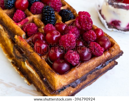 Belgian waffles with raspberries, cherries, blackberries, mulberries and jam Stok fotoğraf © 