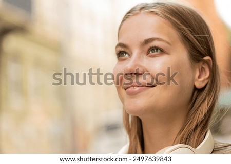 Image, Stock Photo Thoughtful young female tourist standing on rocky seashore and looking away