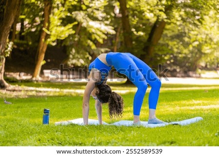 Similar – Image, Stock Photo Flexible young sportswoman practicing yoga on street