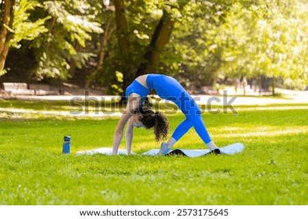 Similar – Image, Stock Photo Flexible young sportswoman practicing yoga on street