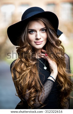 beautiful stylish young woman (girl) in dress and hat