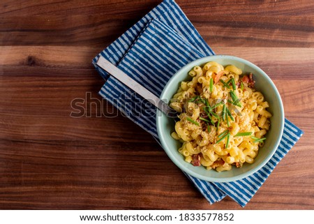 Macaroni and Cheese. Mac n cheese. Macaroni noodles with melted Parmesan, mozzarella cheese, bacon, parsley. Classic American or Italian favorite. Homemade pasta with sauces, meats and cheeses.