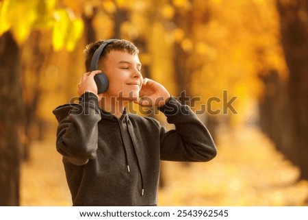 Similar – Image, Stock Photo Teenagers stand with closed eyes in front of a bright wooden wall and enjoy the wind in their hair.