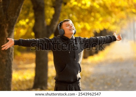 Similar – Image, Stock Photo Teenagers stand with closed eyes in front of a bright wooden wall and enjoy the wind in their hair.