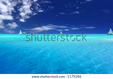 Boats sailing near tropical Motu