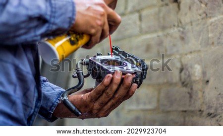 A local mechanic cleaning the throttle body of a car ストックフォト © 