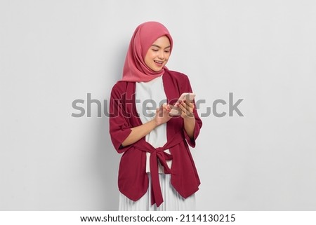 Similar – Image, Stock Photo Positive Muslim woman using smartphone on embankment