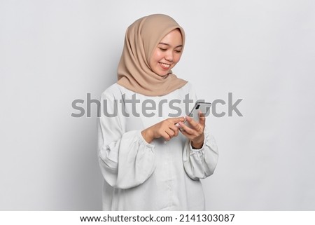 Image, Stock Photo Positive Muslim woman using smartphone on embankment