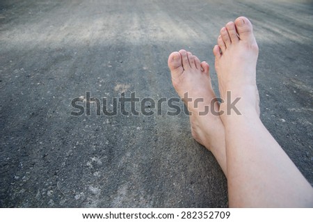 Close up of a woman feet relaxing on concrete floor