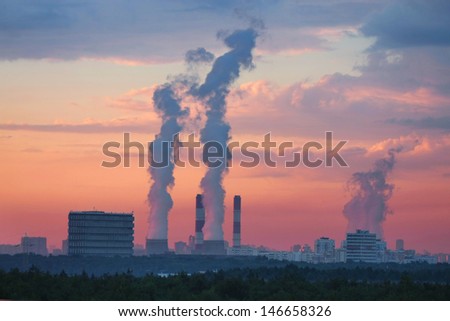 Smoke under the sunset sky in Moscow