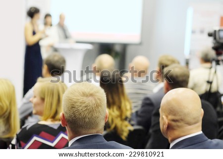 The audience listens to the acting in a conference hall