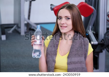 Girl drinks water after training