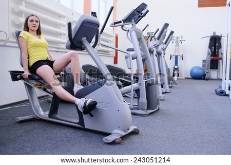 athletic girl is engaged on a stationary bike