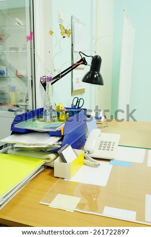 Doctor office table with office tools and lamp