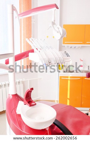 Dental clinic interior design with red chair and tools