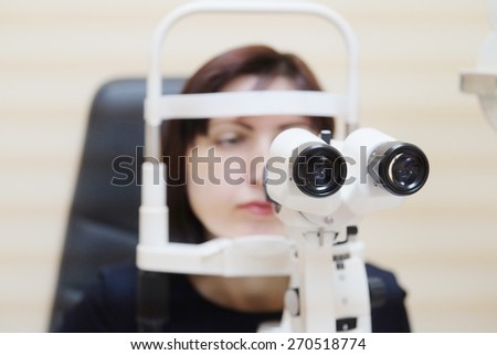 Woman looking into eye test machine