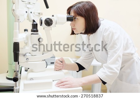 Female doctor optometrist examines eyesight of female patient in eye ophthalmological clinic