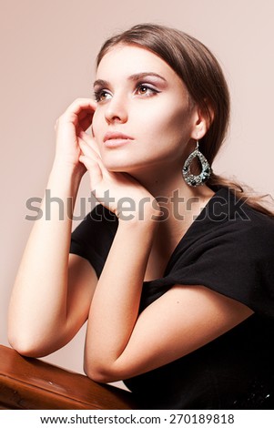 portrait of elegant woman in a luxury simple black dress uniform background
