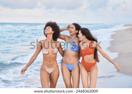 Similar – Image, Stock Photo Smiling women in swimsuits on sandy beach near ocean