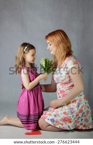 Child giving mother flowers