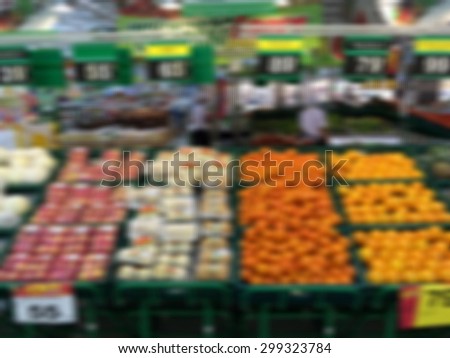 Various fresh fruits on food market stall process in blurred