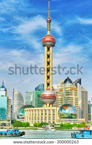 SHANGHAI-MAY 24, 2015. Oriental Pearl Tower on  blue sky background. Tower  470 meter the Oriental Pearl is one of Shanghai\'s tallest buildings, located at Lujiazui finance and trade zone in Pudong