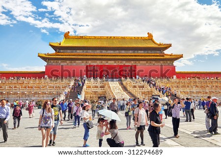 BEIJING, CHINA - MAY 18, 2015: People, tourists walking on the territory of the Forbidden City, palaces, pagodas inside the territory  - the most visited attraction in Beijing and all over China..
