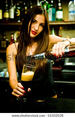 A young female bartender, photographed at work.