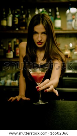 A young female bartender, photographed at work.