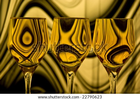 Close up of three wine glasses; back lighting through colored, patterned glass.
