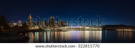 VANCOUVER, BC, CANADA - SEPT 12, 2015: Downtown Vancouver and Canada Place at night, with the North Shore mountains in the background.
