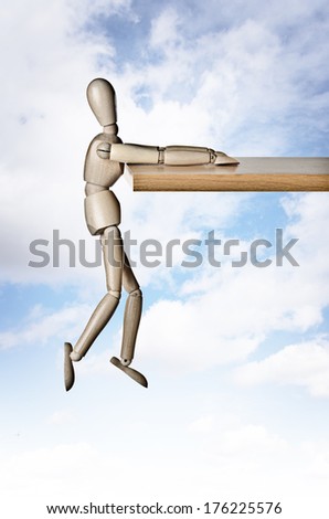 Manikin, anatomical model, hanging off a ledge