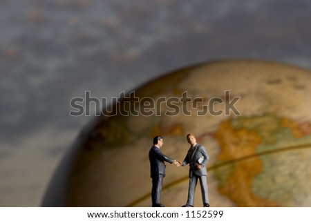 Business figures and globe