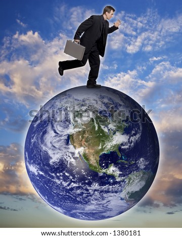 Businessman running on top of the earth