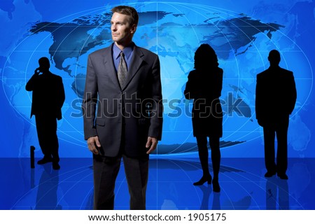Businessman standing in front of an earth map and other business people in silhouette